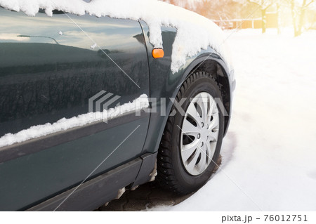 Car is covered with snow. Car is covered with snow. 76012751