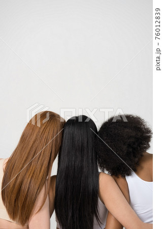 Diverse girls with different hair standing and posing at the studio Diverse girls with different hair standing and posing at the studio 76012839