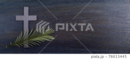 Palm sunday background. Cross and palm on wooden background. 76013445