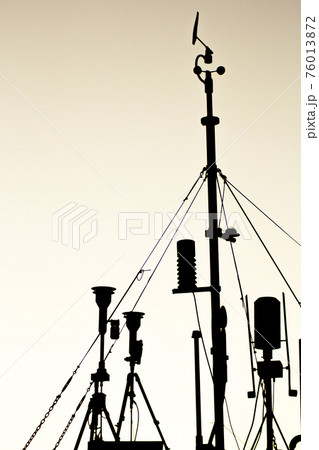 Weather station in silhouette over the sky at sunset 76013872