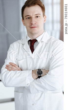 Doctor man headshot while standing in hospital office. Physician at workplace, portrait photo. Medicine and health care concept Doctor man headshot while standing in hospital office. Physician at workplace, portrait photo. Medicine and health care concept 76014601