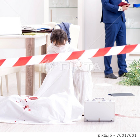 Forensics investigator at the scene of office crime Forensics investigator at the scene of office crime 76017601