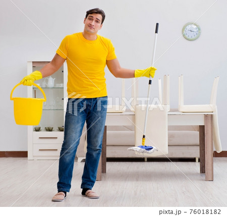 Man cleaning the house helping his wife 76018182
