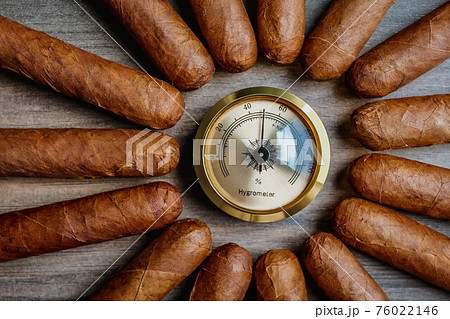 Cigars with humidor hygrometer on the wooden background Cigars with humidor hygrometer on the wooden background 76022146