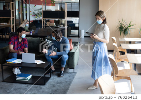 Diverse group of business people working in creative office 76026413