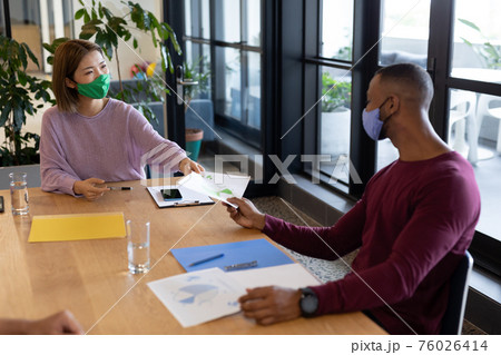 Two diverse business people working in creative office 76026414