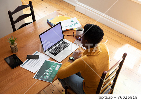 Overhead view of african american woman using laptop while working from home Overhead view of african american woman using laptop while working from home 76026818