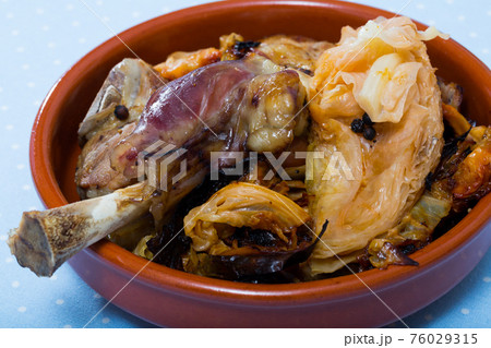 Fried tasty lamb with cabbage prepared and served at clay bowl Fried tasty lamb with cabbage prepared and served at clay bowl 76029315