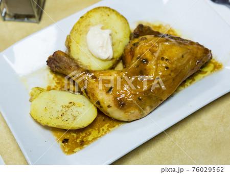 Baked chicken legs with potatoes Baked chicken legs with potatoes 76029562