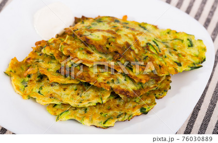 Pancakes from courgettes is tasty vegeterian dish 76030889