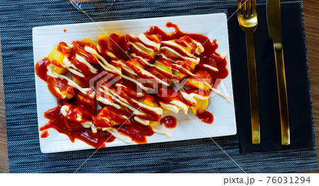 Close up of traditional spanish patatas bravas on plate on tablecloth 76031294