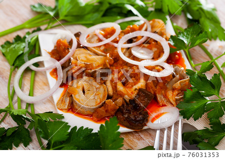 Marinated herring with mushrooms and tomato sauce on plate Marinated herring with mushrooms and tomato sauce on plate 76031353