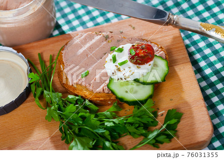 Pate on toasted bread with fresh cheese on wooden board Pate on toasted bread with fresh cheese on wooden board 76031355