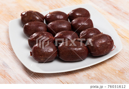 Blood sausages on wooden table 76031612