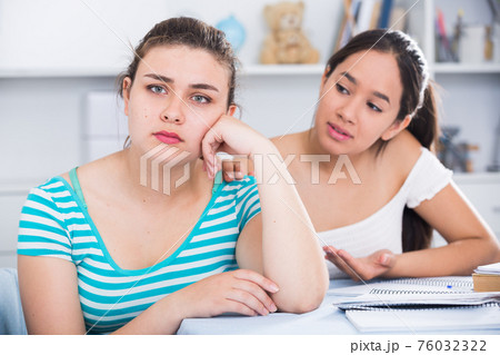 Girl asking for forgiveness from her friend 76032322