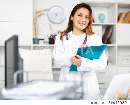 Young female therapist fills out an appointment form on a tablet in the office 76032386