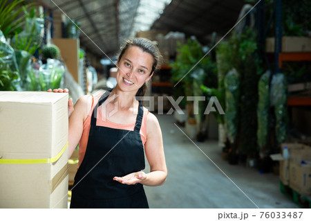 Garden store worker posing at shopping room Garden store worker posing at shopping room 76033487