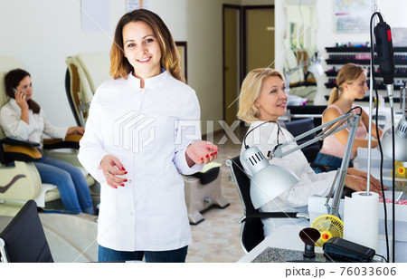 Woman manicurist in nail salon 76033606
