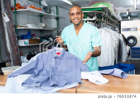 Portrait of male worker of dry-cleaning facility Portrait of male worker of dry-cleaning facility 76033874