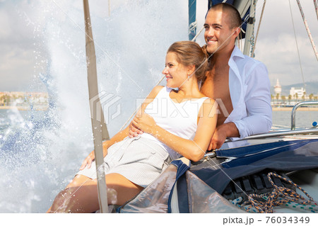Couple enjoying sea trip along coast of Barcelona Couple enjoying sea trip along coast of Barcelona 76034349