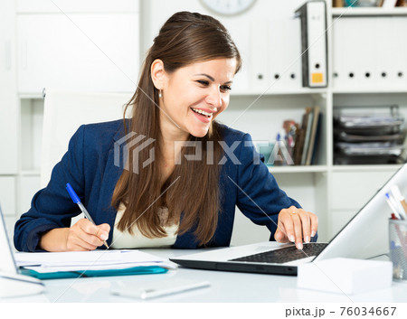 Successful adult business woman using laptop at workplace Successful adult business woman using laptop at workplace 76034667