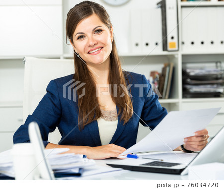 Successful adult business woman using laptop at workplace 76034720