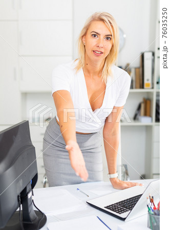 Businesswoman is going to meet visitors in her office 76035250