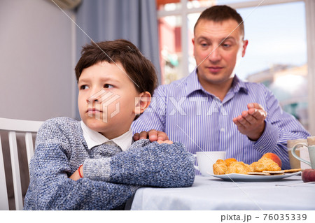 Upset father and offended son arguing in domestic interior 76035339