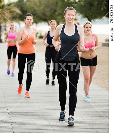 Women jogging during outdoor workout Women jogging during outdoor workout 76035358