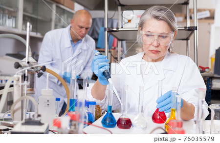 Female scientist working with reagents 76035579