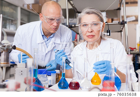 Scientists mixing reagents 76035638