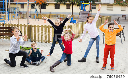 Active kids playing outdoors Active kids playing outdoors 76036429