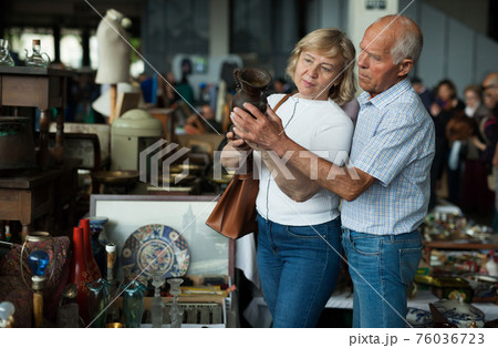 Elderly family choose handmade vase at flea market Elderly family choose handmade vase at flea market 76036723