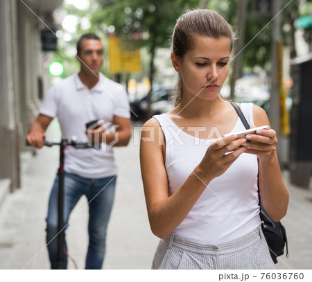 Man and woman using smartphones 76036760