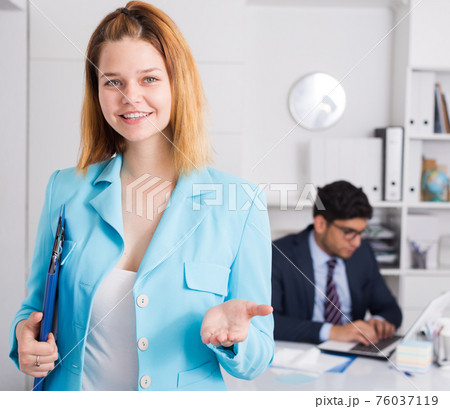 Businesswoman welcoming to company office 76037119