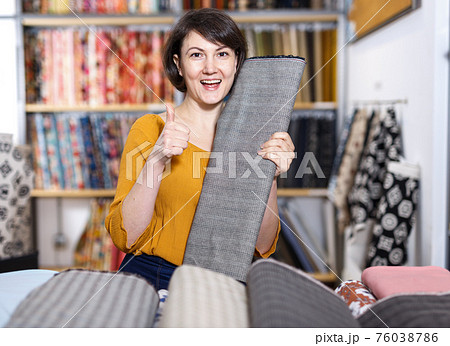 Woman showing thumbs up in tissue store Woman showing thumbs up in tissue store 76038786