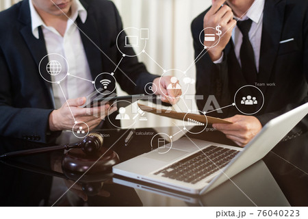 Lawyer businessman and two business partners working together in office. Businessmen sitting at desk and making notes. Lawyer businessman and two business partners working together in office. Businessmen sitting at desk and making notes. 76040223