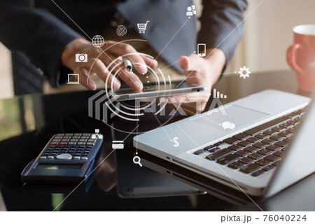 Send a message to a colleague, a businessman, confident in matching a tablet and sitting in office. 76040224