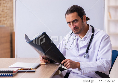 Young male doctor radiologist working in the clinic Young male doctor radiologist working in the clinic 76040737