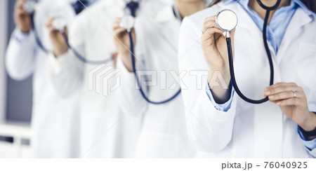 Group of doctors holding stethoscope head close-up. Physicians ready to examine and help patient. Medicine concept 76040925