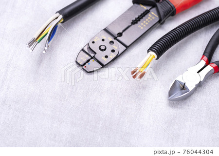wire stripping pliers and cable cutters on the electrician's desk wire stripping pliers and cable cutters on the electrician's desk 76044304