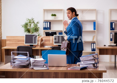 Young male employee working in the office 76044572