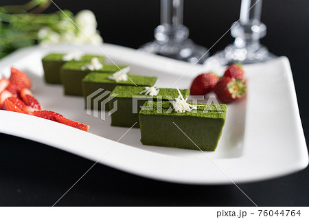 白いお皿に盛り付けられた抹茶のテリーヌといちご 76044764