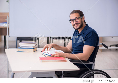 Young male handicapped student in the classroom 76045827