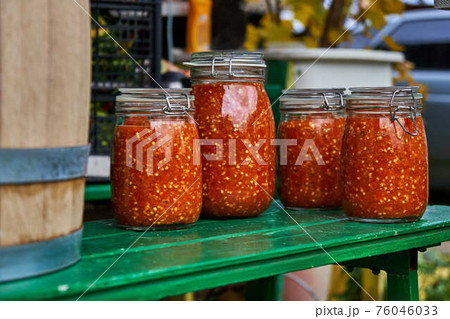 Canning the hot pepper. Glass jars with hot pepper. Hot sauce in jars 76046033