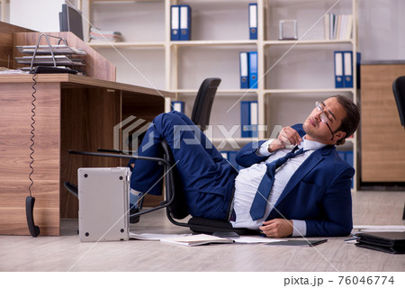 Young male businessman employee unhappy with his work 76046774