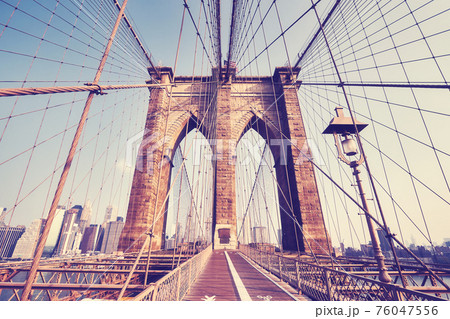 Retro toned picture of Brooklyn Bridge at sunset, New York City, USA. 76047556