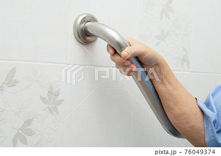Asian senior or elderly old lady woman patient use toilet bathroom handle security in nursing hospital ward, healthy strong medical concept. 76049374