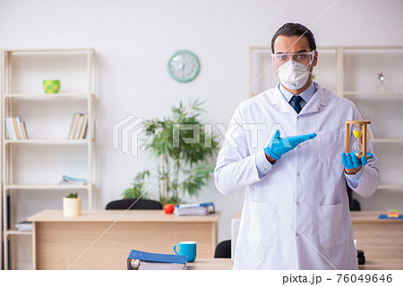 Young male doctor virologist in the office Young male doctor virologist in the office 76049646