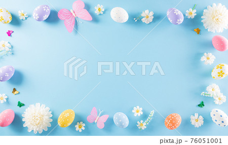 Happy easter! Colourful of Easter eggs in with flower on pastel blue background. Greetings and presents for Easter Day celebrate time. Flat lay ,top view. 76051001